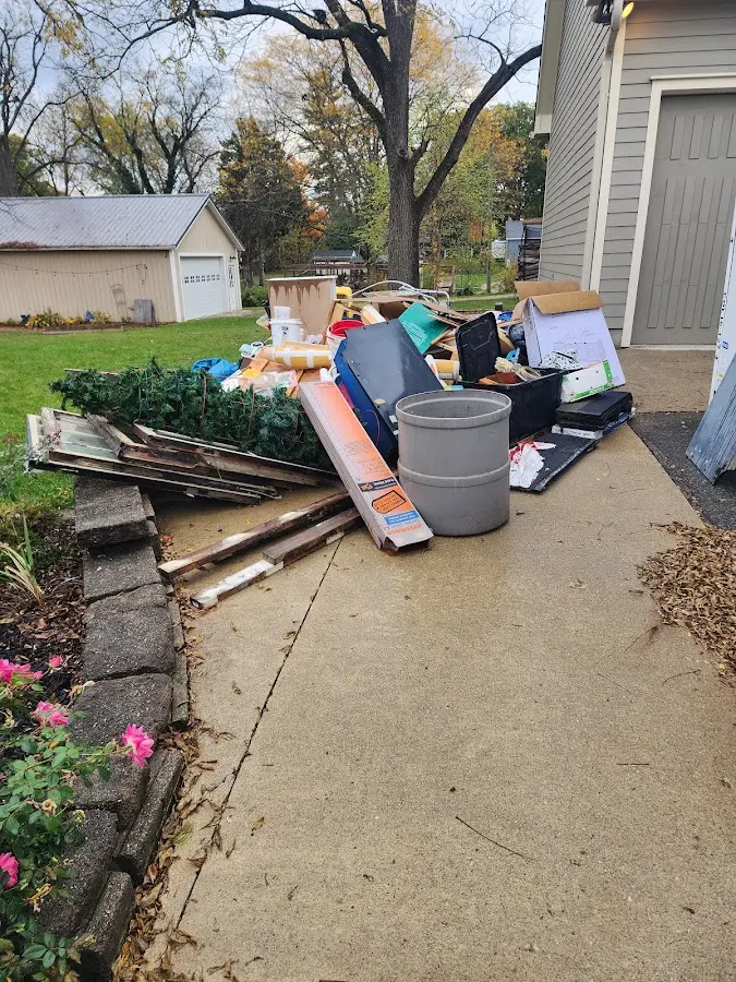 Dumpster being loaded with debris for Commercial Dumpster Rental in North Terre Haute